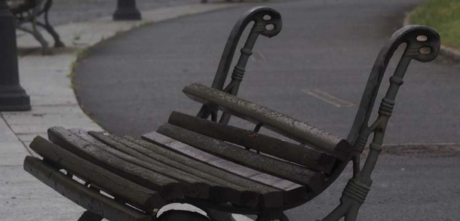 El mal estado de las losetas y bancos dificulta el uso del paseo marítimo de Caranza