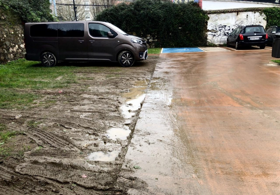 El aparcamiento en los espacios verdes ha deteriorado el parking público alternativo del barrio de Canido